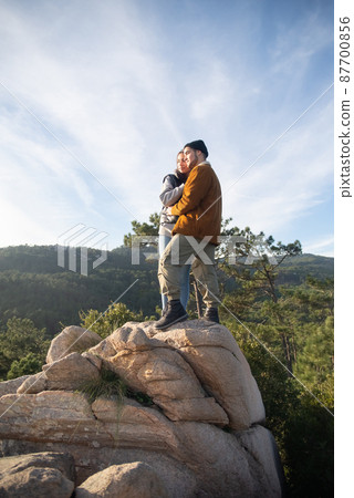 Loving couple hiking in autumn Loving couple hiking in autumn 87700856