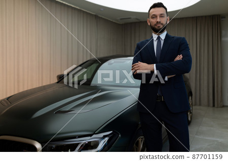 respectable successful businessman in a strict business suit against the background of an expensive respectable successful businessman in a strict business suit against the background of an expensive 87701159