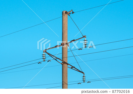 View of concrete power pole and electric lines View of concrete power pole and electric lines 87702016