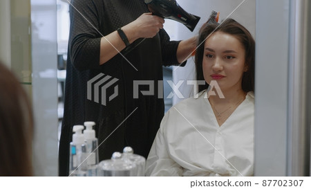 Beautiful girl at the hairdresser. The girl got her hair done. Beauty salon Beautiful girl at the hairdresser. The girl got her hair done. Beauty salon 87702307