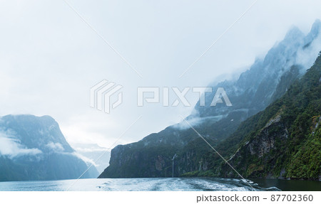 Milford Sound in the rain seen from a cruise ship in Fiordland National Park, New Zealand Milford Sound in the rain seen from a cruise ship in Fiordland National Park, New Zealand 87702360