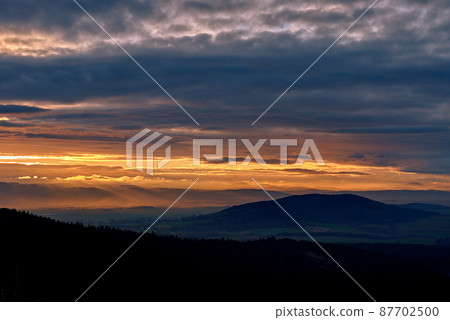 Sunset dramatic sky over mountains shape Sunset dramatic sky over mountains shape 87702500