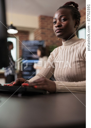 Confident african american network developer engineering application for company database 87702891