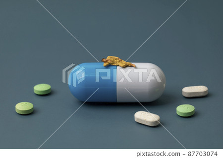 睡在膠囊藥片上的微型男人 87703074