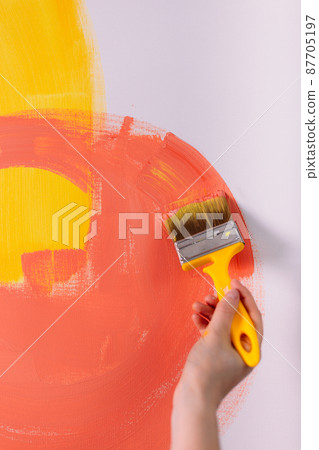 Female hands hold paint brushes. Painting a picture on an easel 87705197