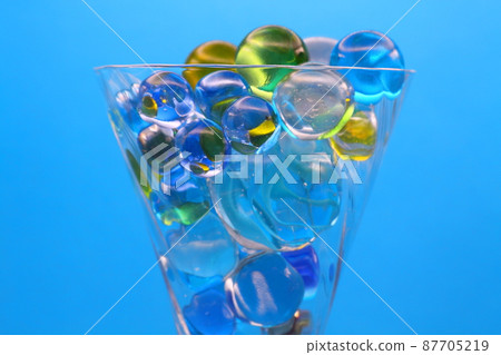 Glasses and colorful marbles 87705219