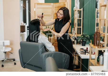 The makeup artist girl applies powder or blush to her client, completes the image. Beauty, makeup, style The makeup artist girl applies powder or blush to her client, completes the image. Beauty, makeup, style 87705468