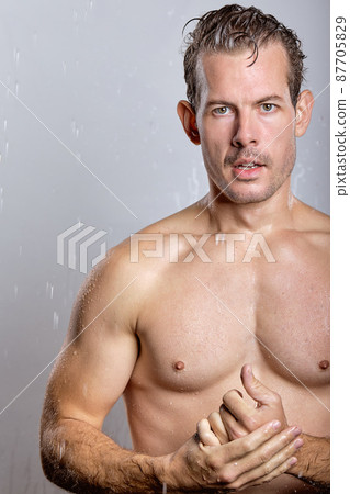 shirtless male posing at camera, half-naked man looks at camera, calm and serious. isolated shirtless male posing at camera, half-naked man looks at camera, calm and serious. isolated 87705829