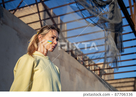 Ukrainian woman with a flag on the cheek 87706336