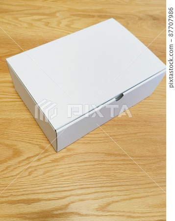 A white cardboard box on the desk A white cardboard box on the desk 87707986