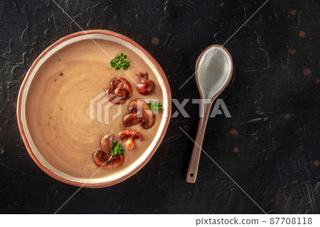 Mushroom soup, shot from the top on a black background 87708118