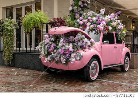 Vintage colorful auto loaded with flowers and transformed into decoration 87711105