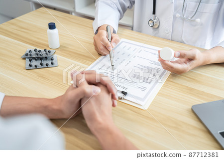 Doctor discussing with the patient using the medicine something and recommend treatment methods, Presenting results on report, Medicine and Healthcare concept Doctor discussing with the patient using the medicine something and recommend treatment methods, Presenting results on report, Medicine and Healthcare concept 87712381