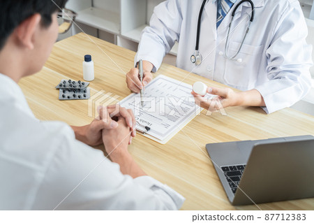 Doctor discussing with the patient using the medicine something and recommend treatment methods, Presenting results on report, Medicine and Healthcare concept Doctor discussing with the patient using the medicine something and recommend treatment methods, Presenting results on report, Medicine and Healthcare concept 87712383