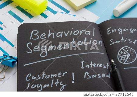 Behavioral segmentation sign with marks on the dark notepad. 87712545