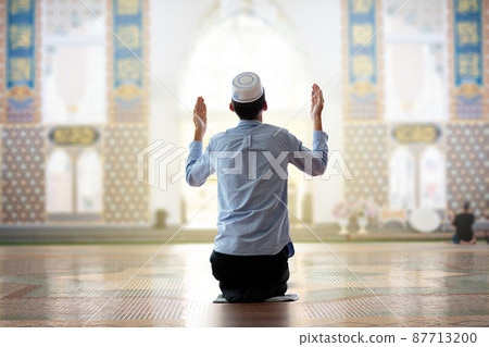 Ramadan Kareem greeting. Man praying. 87713200