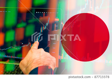 Japan uptrend of the economy. Man hand shows on the increasing candle stick graph chart in the stock market with the flag on the background, March 2022, San Francisco, USA Japan uptrend of the economy. Man hand shows on the increasing candle stick graph chart in the stock market with the flag on the background, March 2022, San Francisco, USA 87713378