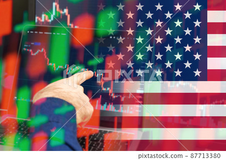 USA downtrend of the economy in a world crisis. Man hand shows on the decreasing candle stick graph chart in the stock market with the flag on the background, March 2022, San Francisco, USA USA downtrend of the economy in a world crisis. Man hand shows on the decreasing candle stick graph chart in the stock market with the flag on the background, March 2022, San Francisco, USA 87713380