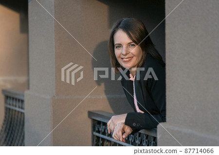 Happy business woman in black suit. Smiling female boss on break. Business casual. Model looking at the camera Happy business woman in black suit. Smiling female boss on break. Business casual. Model looking at the camera 87714066