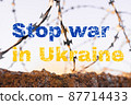 Stop the war in Ukraine. Inscription on a background of barbed wire and blue sky. Russia's invasion of Ukraine, a request for help in the whole world 87714433