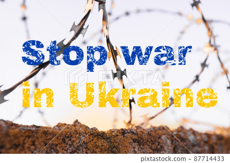 Stop the war in Ukraine. Inscription on a background of barbed wire and blue sky. Russia's invasion of Ukraine, a request for help in the whole world Stop the war in Ukraine. Inscription on a background of barbed wire and blue sky. Russia's invasion of Ukraine, a request for help in the whole world 87714433