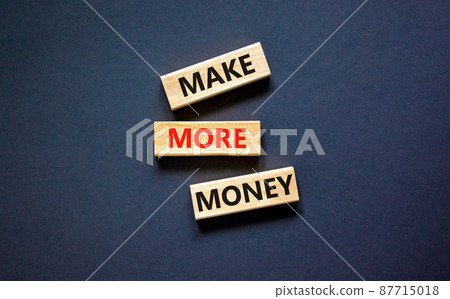 Make more money symbol. Concept words Make more money on blocks on beautiful black table black background. Business and make more money concept. Copy space. 87715018
