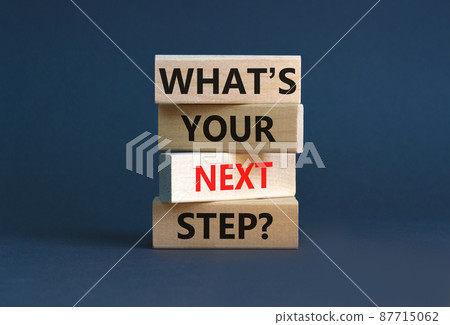 What is your next step symbol. Concept words What is your next step on blocks. Beautiful grey table grey background. What is your next step business concept. Copy space. What is your next step symbol. Concept words What is your next step on blocks. Beautiful grey table grey background. What is your next step business concept. Copy space. 87715062