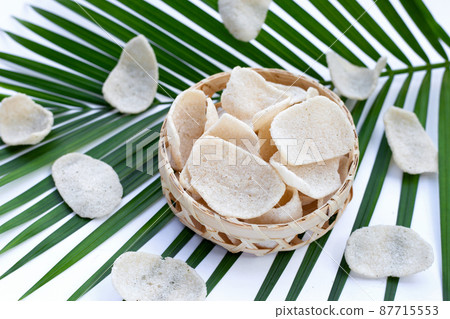 Prawn crackers in bamboo basket. Shrimp crispy rice snack 87715553