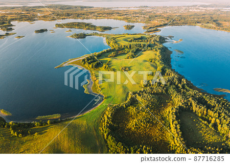 Braslaw Or Braslau, Vitebsk Voblast, Belarus. Aerial View Of Nedrava Lake, Green Forest And Meadow Landscape In Sunny Autumn Morning. Top View Of Beautiful European Nature From High Attitude. Bird's Braslaw Or Braslau, Vitebsk Voblast, Belarus. Aerial View Of Nedrava Lake, Green Forest And Meadow Landscape In Sunny Autumn Morning. Top View Of Beautiful European Nature From High Attitude. Bird's 87716285