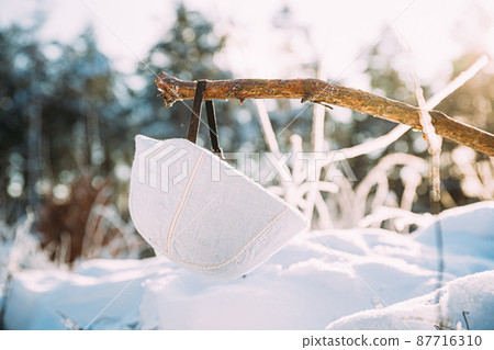 German Wehrmacht Infantry Soldiers White Helmet hanging on wooden banch in snow winter forest. World War II old army equipment ammunition. Metal Helmet Of German Infantry Wehrmacht Soldier At World German Wehrmacht Infantry Soldiers White Helmet hanging on wooden banch in snow winter forest. World War II old army equipment ammunition. Metal Helmet Of German Infantry Wehrmacht Soldier At World 87716310