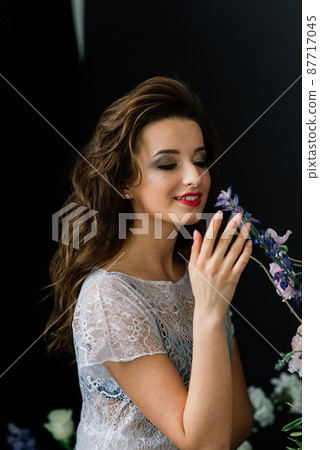 Bride in a white wedding dress in the interior of a Villa at a wedding. Morning of the bride. Bride in a white wedding dress in the interior of a Villa at a wedding. Morning of the bride. 87717045