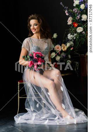 Bride in a white wedding dress in the interior of a Villa at a wedding. Morning of the bride. Bride in a white wedding dress in the interior of a Villa at a wedding. Morning of the bride. 87717046