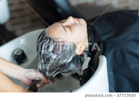 Woman having shampoo at a beauty salon Woman having shampoo at a beauty salon 87717630