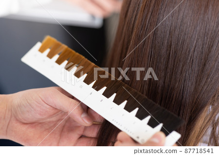 A woman getting a hair color at a beauty salon A woman getting a hair color at a beauty salon 87718541