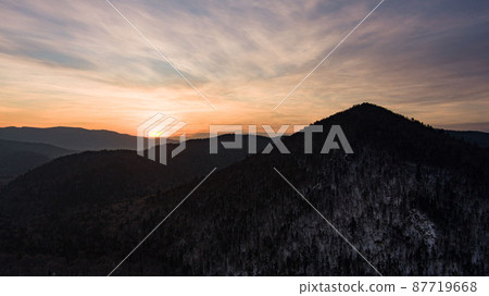 Aerial drone view in mountain forest. Winter landscape. Snowy Fir and Pine trees. Snowy tree branch in a view of the winter forest. Winter landscape, forest, trees covered with frost, snow. Aerial drone view in mountain forest. Winter landscape. Snowy Fir and Pine trees. Snowy tree branch in a view of the winter forest. Winter landscape, forest, trees covered with frost, snow. 87719668