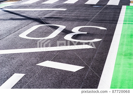 Road markings written on the reflecting road surface Zone 30 and stop lines and pedestrian crossings High contrast 87720068