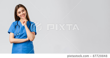 Medical workers, healthcare, covid-19 and vaccination concept. Upbeat smiling pretty nurse, doctor in blue scrubs, working clinic, looking with enthusiastic gaze camera, listening to coworker 87720848