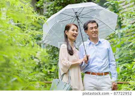 Senior couple outdoor date rainy season 87722952