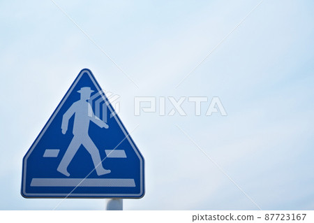 There is a road sign "pedestrian crossing" There is a road sign "pedestrian crossing" 87723167
