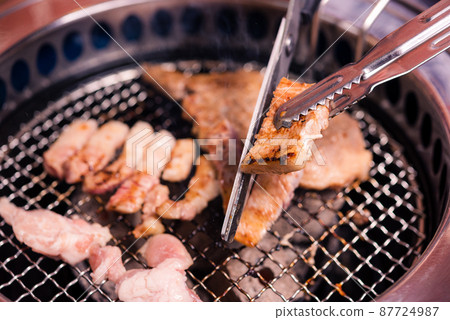 Grilling meat pork Korean BBQ traditional style on stove serve in restaurant Grilling meat pork Korean BBQ traditional style on stove serve in restaurant 87724987