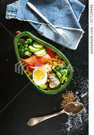 broccoli salnon and boiled egg in ceramic bowl served with corn and seeds 87726946