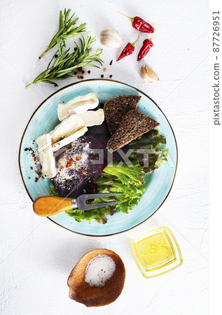 Camamber, beet salad and bread on blue plate Camamber, beet salad and bread on blue plate 87726951