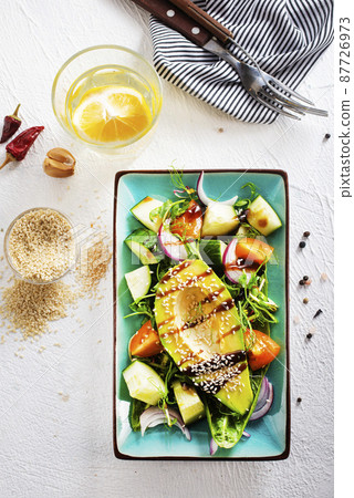 Healthy cuisine. Fresh green salad with avocado Healthy cuisine. Fresh green salad with avocado 87726973