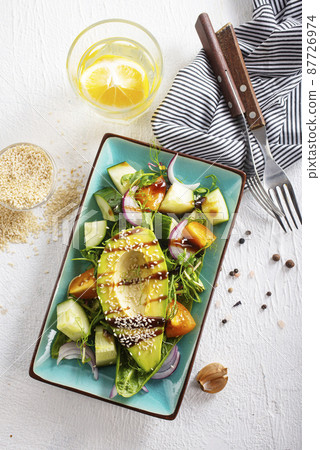 Healthy cuisine. Fresh green salad with avocado Healthy cuisine. Fresh green salad with avocado 87726974