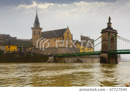 Landscape French commune of Seyssel with the flowing Rhone River and a bridge 87727040