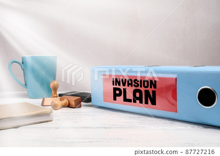 Invasion Plan. Documents in a blue folder on the office desk Invasion Plan. Documents in a blue folder on the office desk 87727216