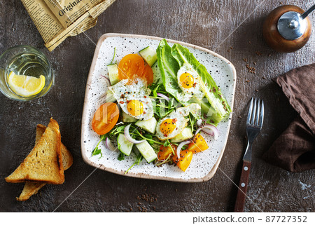 fried eggs with vegetables, top view, diet salad with quail eggs 87727352