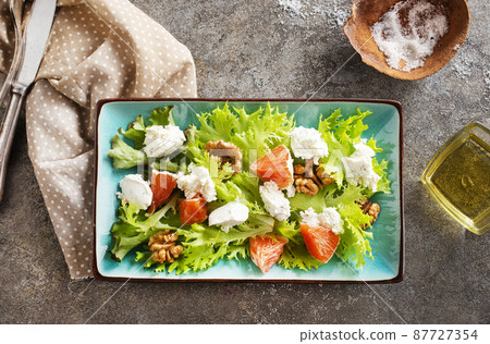 salad with white cheese and vegetables on plate 87727354