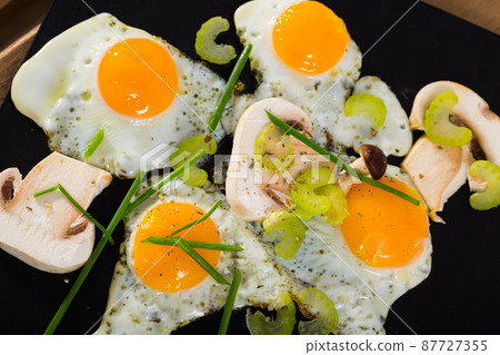 Fried quail eggs with champignons 87727355