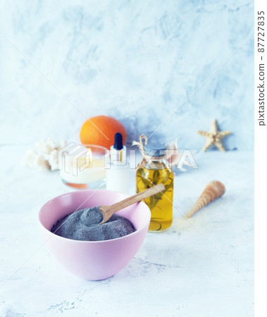 Blue clay, citruses, cream, aromatic oil, healthy tinctures and seashells on a light background, spa, natural ingredients, body care 87727835